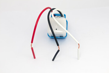 Three colored wires for automatic street light control on a white background.