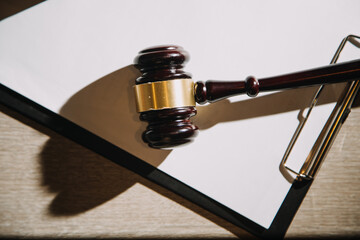 Justice and law concept.Male judge in a courtroom with the gavel, working with, computer and...