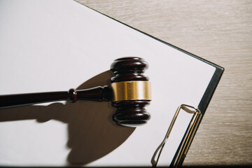 Justice and law concept.Male judge in a courtroom with the gavel, working with, computer and...