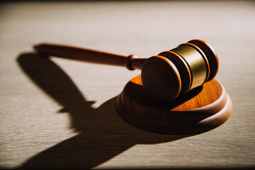 Justice and law concept.Male judge in a courtroom with the gavel, working with, computer and...