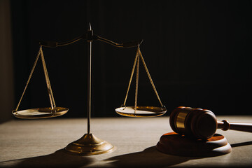 Justice and law concept.Male judge in a courtroom with the gavel, working with, computer and...