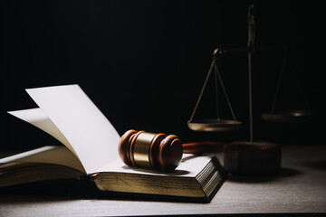Justice and law concept.Male judge in a courtroom with the gavel, working with, computer and...