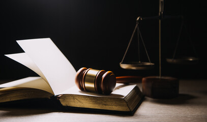 Justice and law concept.Male judge in a courtroom with the gavel, working with, computer and...