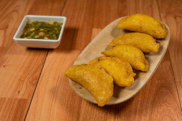 Colombian empanada with spicy sauce