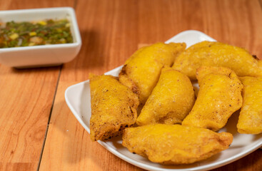Colombian empanada with spicy sauce