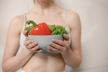 Cropped photo of woman with lots of healthy fresh vegetables on a plate