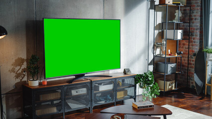 Chroma Key Green Screen Display on TV Set in Modern Living Room. Modern Appartment Interior With...