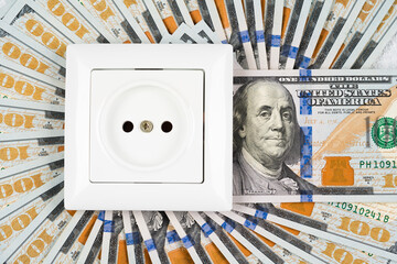 White socket over many 100 dollars banknotes as background. Increasing prices for electricity in the world. High energy cost, world energy and power industry crisis concept