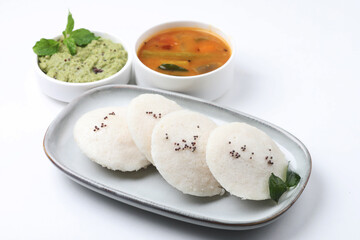 Idly sambar or Idli with Sambhar and green, red chutney. Popular South indian breakfast