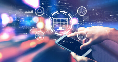 Online meeting theme with person using a smartphone in a city at night