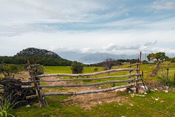 A split rail fence along a countryside field. 