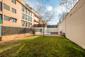 Obraz premium Facades of urban residential buildings with landscaped common areas and a pool covered with a canvas to spend the winter