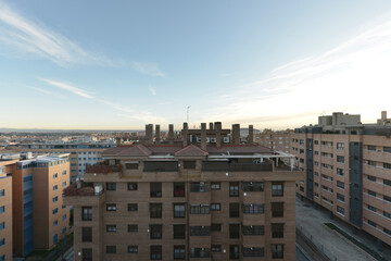 Facades and roofs of houses at dawn on a winter day