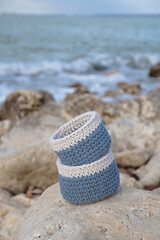 Blue baskets on the background of stones and the sea