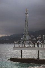 Eiffel Tower with mountains and sea in the background