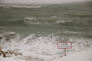 Stormy sea and snowy landscape