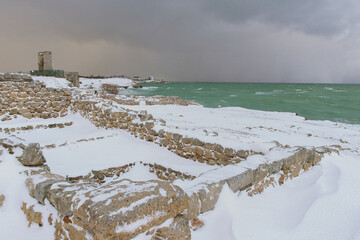 Stormy sea and snowy landscape