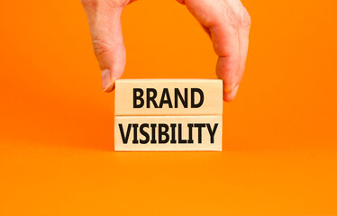 Brand visibility symbol. Concept words Brand visibility on wooden blocks. Beautiful orange table...