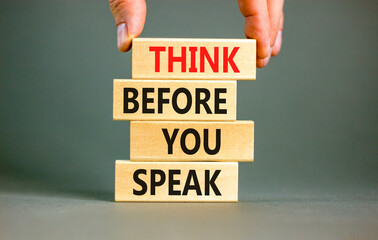 Think before you speak symbol. Concept words Think before you speak on wooden cubes. Beautiful grey...