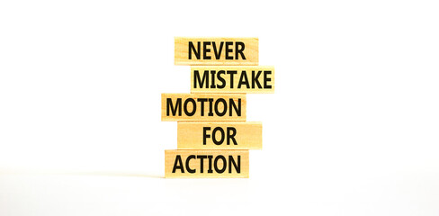 Mistake or action symbol. Concept words Never mistake motion for action on wooden blocks. Beautiful white table white background. Business mistake or action concept. Copy space.