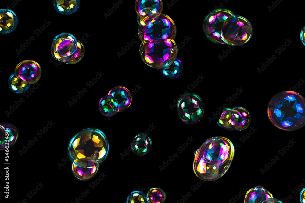 Wall mural soap bubbles isolated on a black background