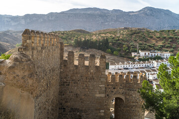 Obraz premium Alcazaba de Antequera. old medieval castle. stone walls, towers, stone buildings. horizontally and vertically, sunlight, blue sky and clouds
