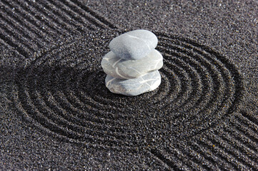Fototapeta na wymiar textured sand and stone in Japanese zen garden