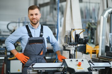 Factory for aluminum and PVC windows and doors production. Manual worker assembling PVC windows and...