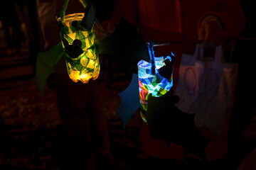 Homemade children lanterns glowing in the darkness on a traditional procession of lights on St....