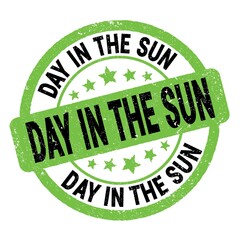 DAY IN THE SUN text written on green-black round stamp sign.
