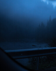 Dark view of river in the evening with heavy mist