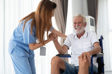 Fototapeta premium Caring nurse with senior man sitting in the bedroom . caucasian man. Discussing. Caring caregiver and senior citizen. Nurse helping senior patient . Young nurse helping elderly man