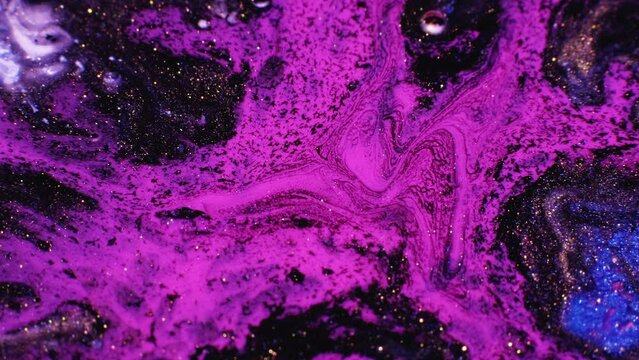 Mixing colors. Fluid magic. Creative painting. Purple stream of liquid paint floating and mixing together with black in macro shooting.