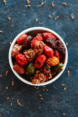 assorted candied peanuts in a ceramic bowl