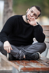 Natural looking guy posing outdoors, wearing casual clothes