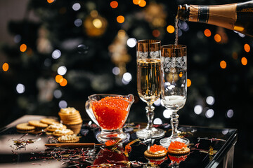 Delicious snacks with cream cheese and red caviar with glass of champagne, Festive drink. Valentins...