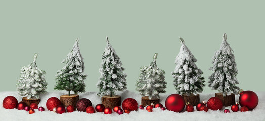 Christmas background in winter, snow landscape. Christmas trees with red Xmas decoration in row, panorama, banner with copy space - 546635451