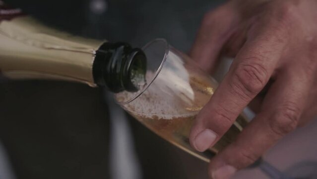 pouring champagne into a glass
