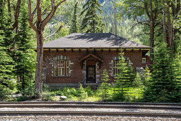 Fototapeta na wymiar Abandoned building near train tracks in Yoho National Park and Field, British Columbia