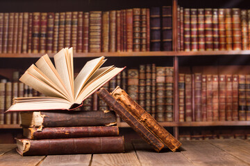 Vintage old hardback books, diary, fanned pages on wooden desk table and grunge background Daylight. Books stacking. Back to school. Copy Space. Education background.