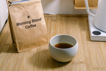 cup of coffee and coffee bag with text
