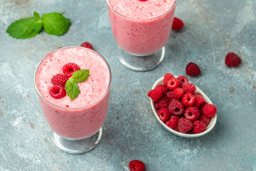 Yogurt smoothie with raspberries in glass on blue marble table. Natural detox. Long banner format