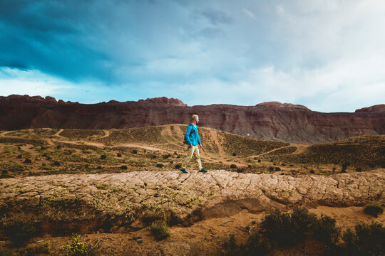 Side view of male hiker walking against mountains at Canyonlands National Park
