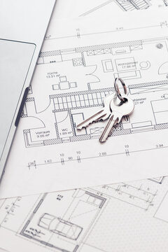 key and architectural blueprint map or drawing of house or future home at landlord real estate agent