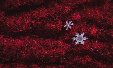 Close up of two snowflakes on a red cloth