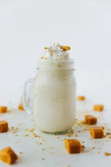 Keuken spatwand met foto Vertical shot of refreshing caramel milkshake © Jeffrey Bethers/Wirestock Creators