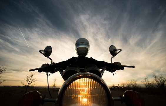 Centered Perspective Silhouette Of A Woman Sitting On Her Vintage Motorcycle