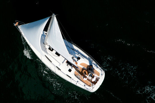 Aerial view of a sailing yacht cruising in Pittwater on the North Shore from Sydney, Australia.