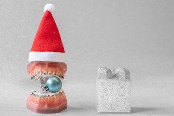 Lustiger zahnärztlicher Weihnachtshintergrund mit Platzhalter. Zahnmodell mit festsitzender...