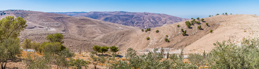 A panorama view south from the approach to Mount Nebo, Jordan in summertime